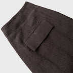 Dark brown pants with a pocket on a light gray background