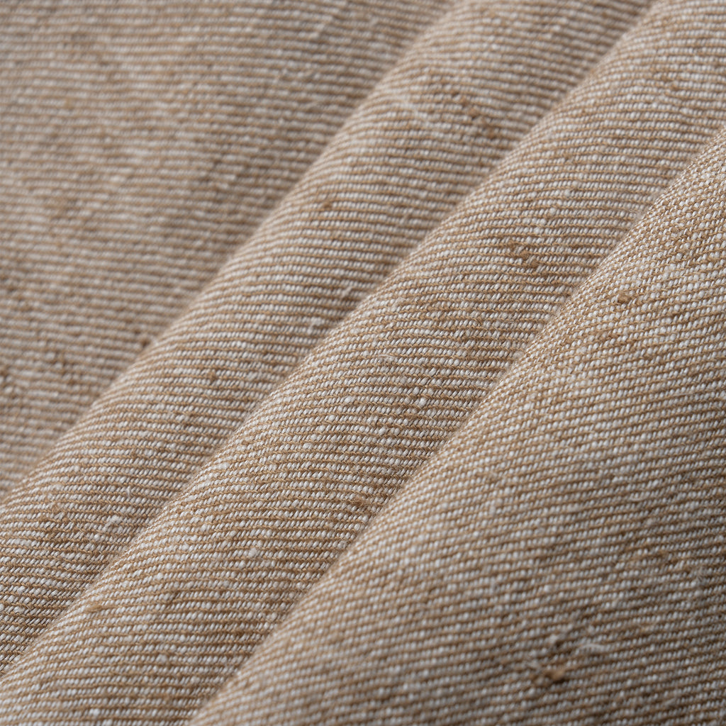 Close-up of beige textured fabric with a subtle pattern