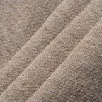 Close-up of beige textured fabric with a subtle pattern