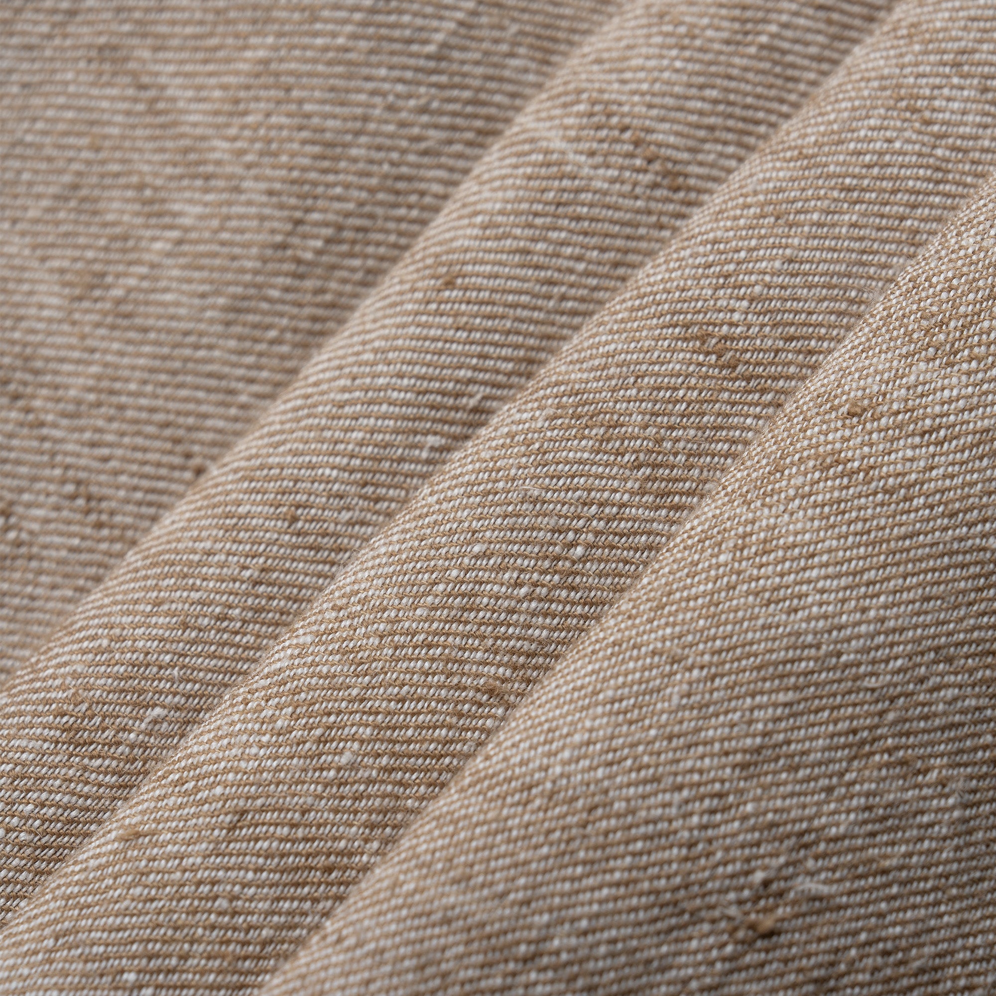 Close-up of beige textured fabric with a subtle pattern