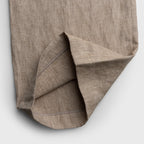 Close-up of a brown fabric with a textured pattern on a white background