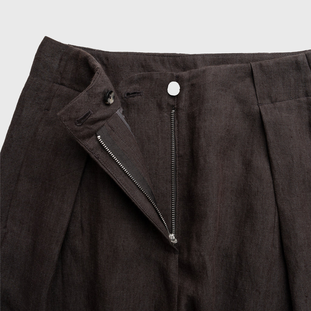 Dark mocha pants with a zipper detail on a light gray background