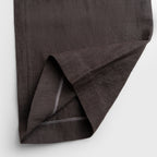 Dark brown fabric folded on a light gray background