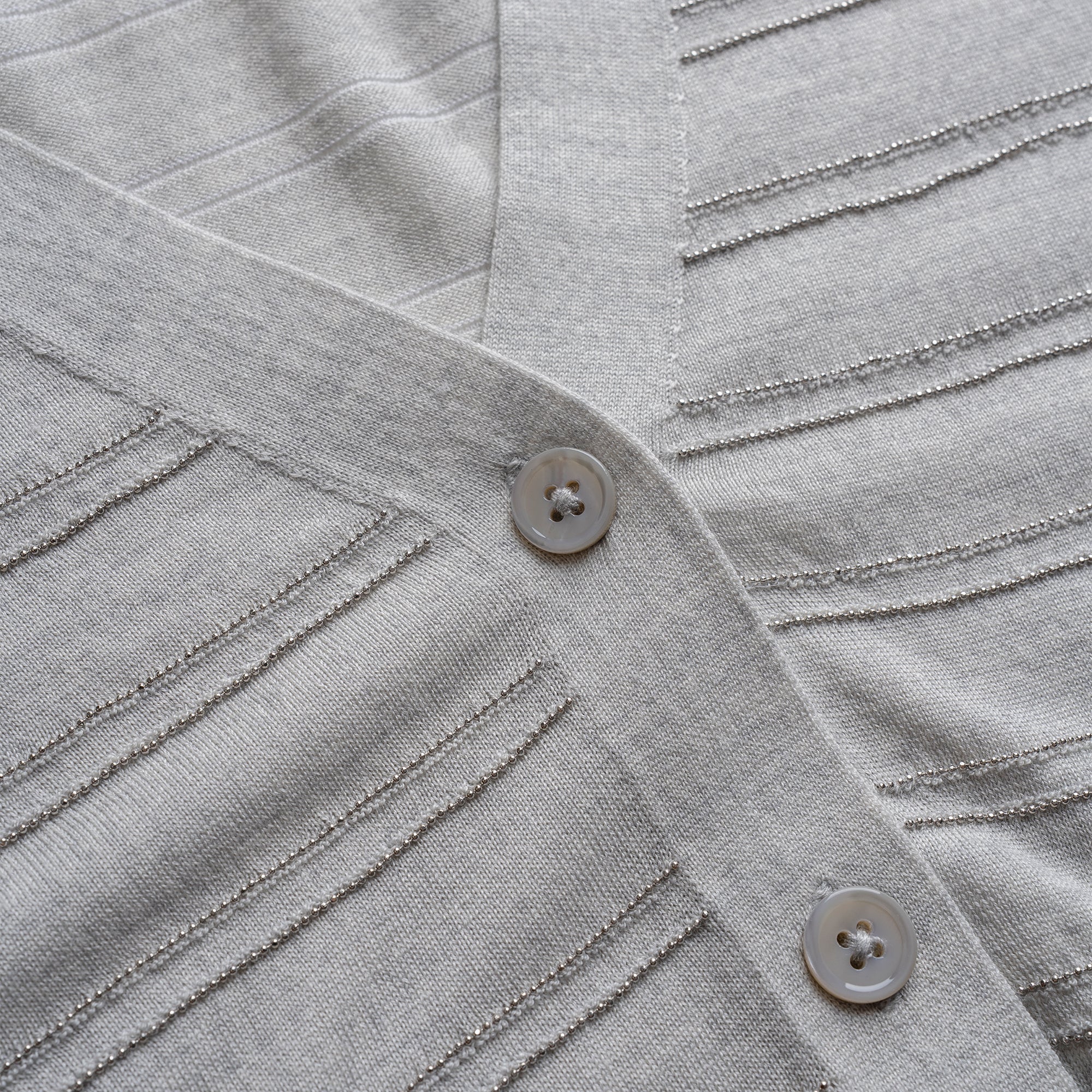 Close-up of a gray textured fabric with buttons
