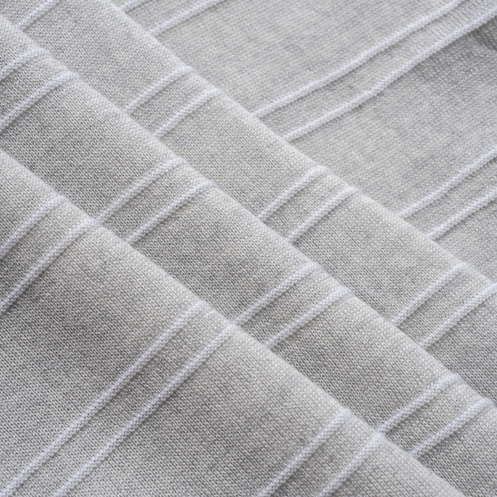 Close-up of textured gray fabric with a diamond pattern